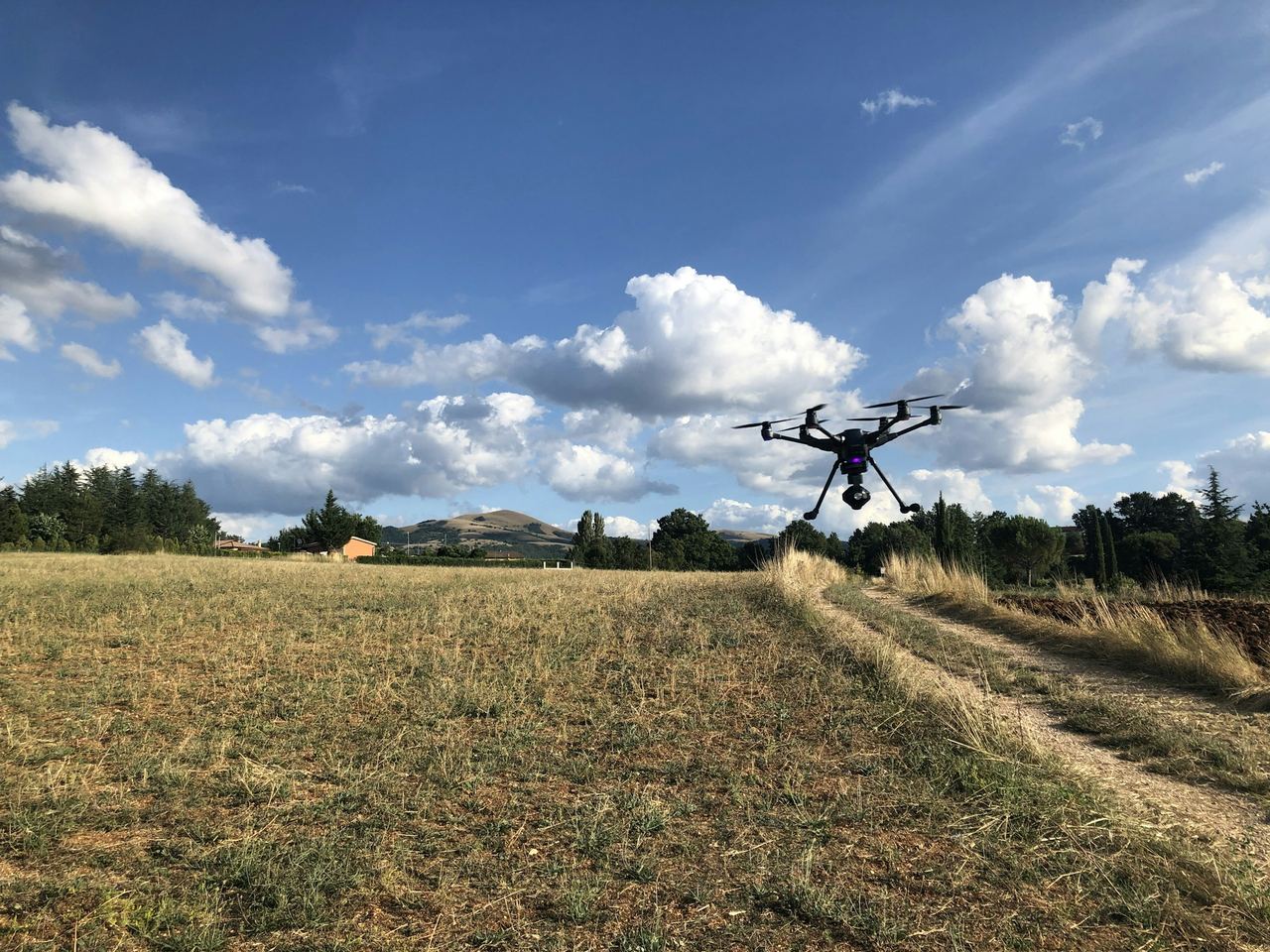 A drone flying low over a farm field