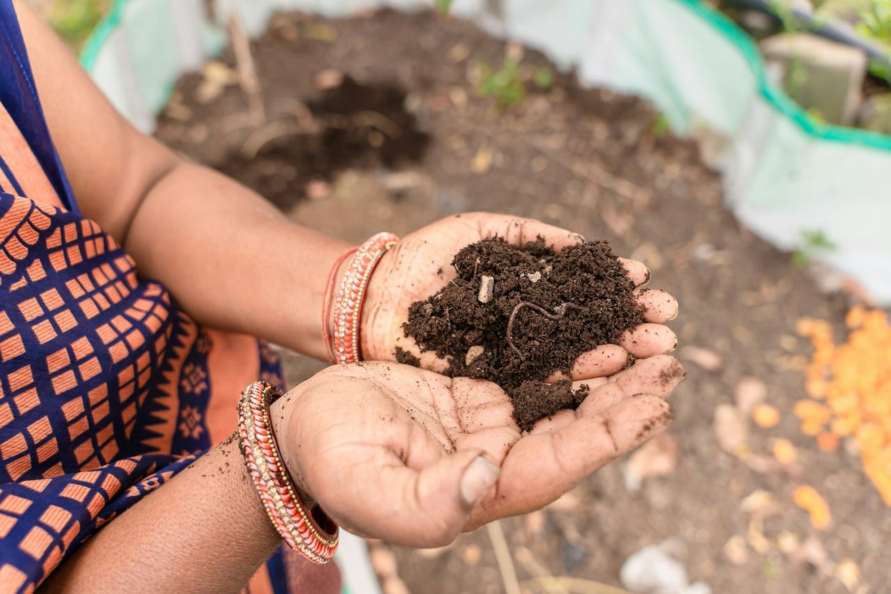 A farmer holding a handful of soil