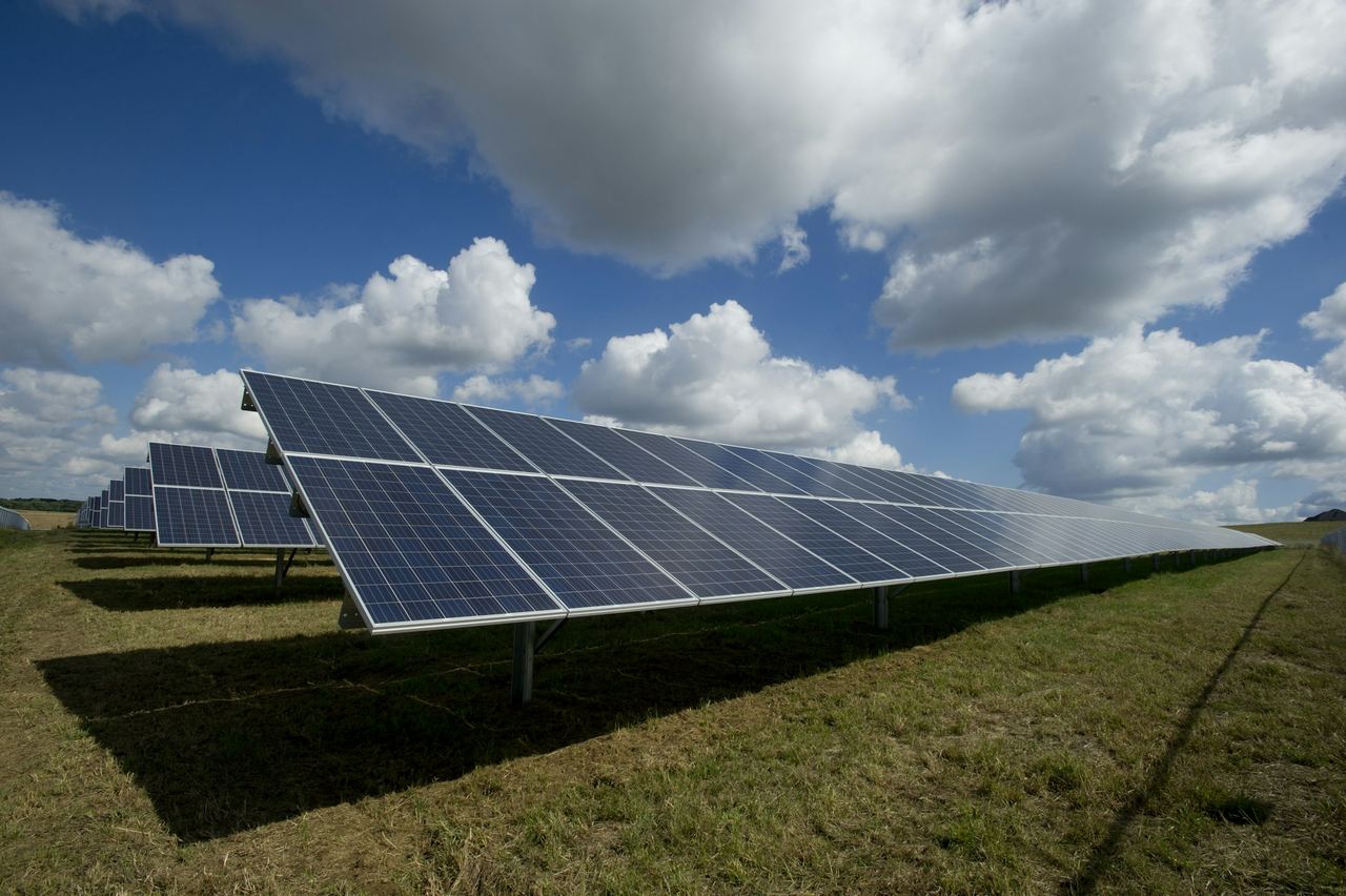 Solar panels installed in a green field