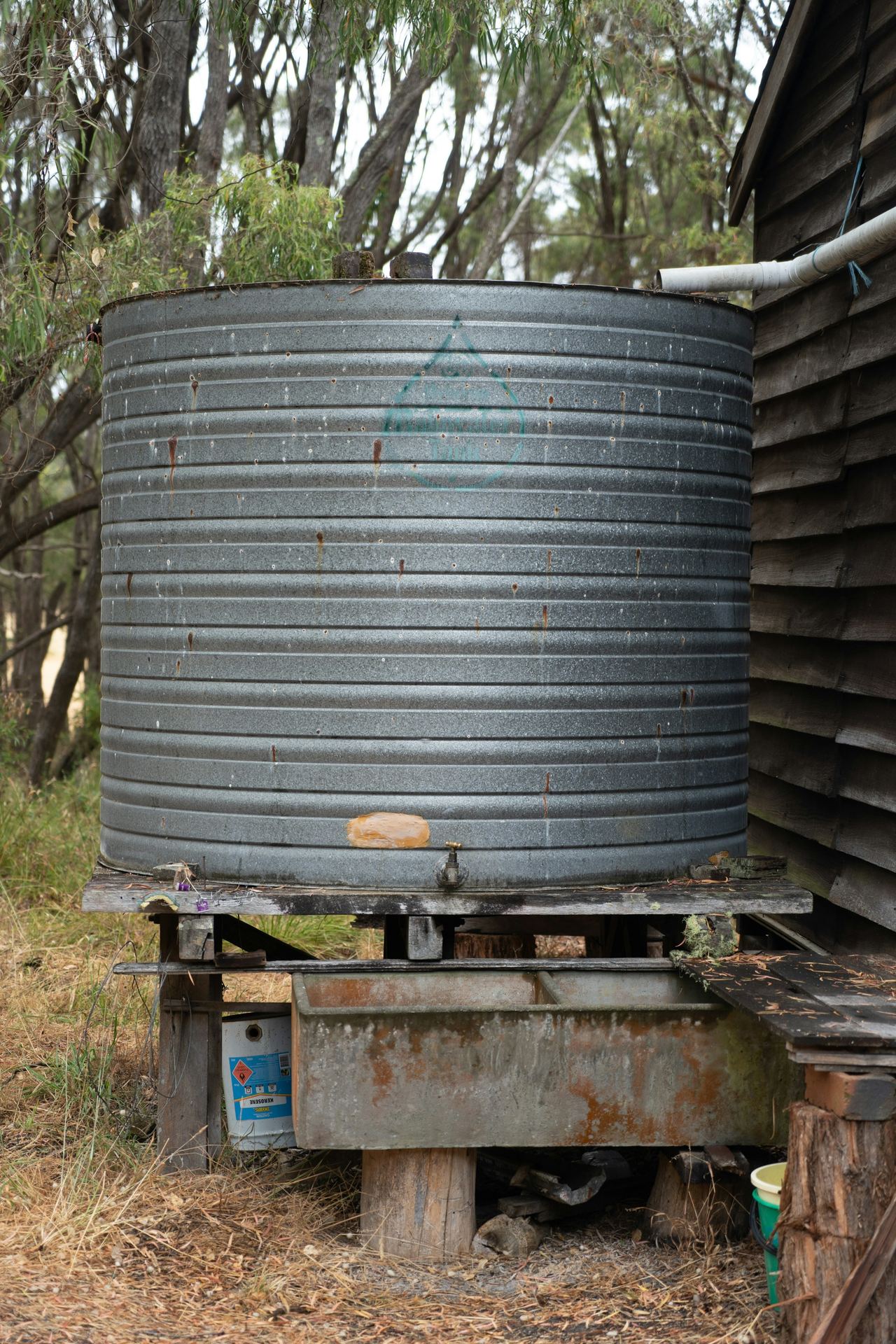 A farm water storage tank on a raised stand